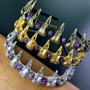 Detail of gothic raven skull headbands with amethyst beads in bronze gold and silver
