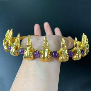Macro view of gothic crown featuring golden bird skull and purple amethyst beads