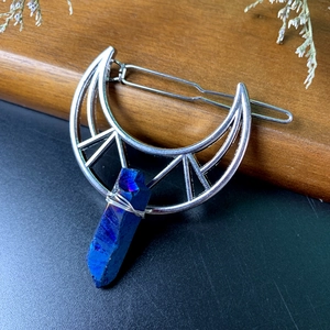 Detailed wire-wrapped crescent moon hair clip featuring a raw purple crystal stone