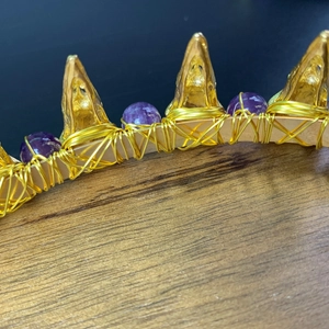 Detail of handmade golden wire-wrapped headband with purple amethyst beads and spikes