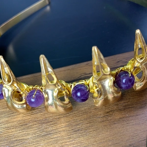 Detail of gothic raven skull headband with purple beads and golden wire wrapping