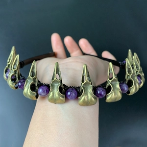 Detailed close-up of gothic raven skull headband with purple crystal beads