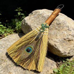 Handcrafted decorative altar broom with peacock feather and green viking dragon pendant