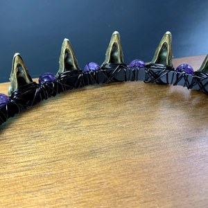 Detailed macro view of Gothic crown featuring bronze spikes and purple beads on wire headband