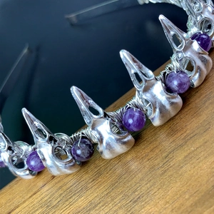 Close-up of gothic raven skull headband with purple amethyst beads and silver wire art