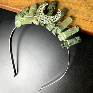 Detail of handmade silver crown headband with natural green crystal quartz and moon