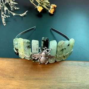 Detail of handmade crystal crown with bee charm and green quartz stones wire wrapped