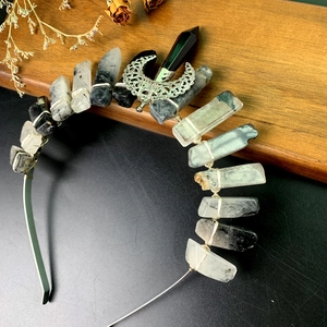 Detailed close-up of handmade quartz crystal headband with crescent moon and wire wrapping