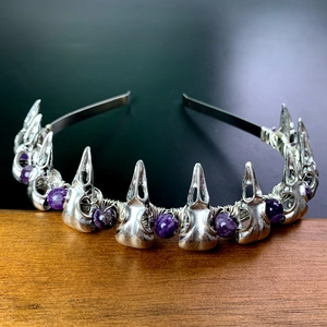 Detailed view of silver crow skulls and purple amethyst beads on gothic headband