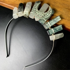 Close-up of handmade natural crystal headband featuring a metal moon and wire wrapping