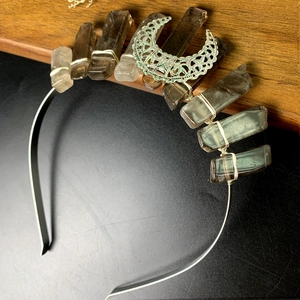Macro view of handmade crystal crown with natural stones and antique bronze moon accessory