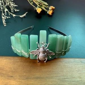 Close-up of green crystal stones and vintage silver bee detail on handmade headband