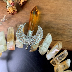 Detail of handcrafted moon crown with yellow crystals and silver wire wrapping