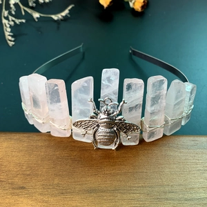 Close-up of pink crystal columns and silver bee ornament on handmade headband