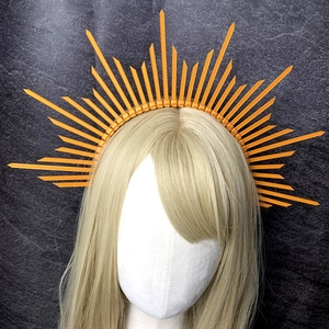 Detail of orange sunburst halo crown headpiece with sharp spikes for costume party