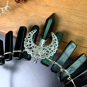 Macro detail of gothic black crystal crown with silver moon and wire-wrapped stones