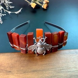 Detail of handmade crystal crown headband with silver bee charm and orange stone petals