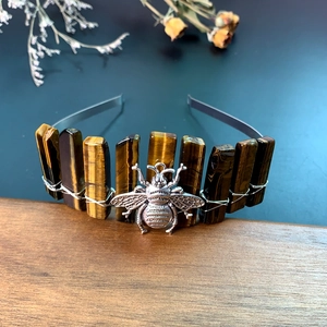 Detailed close-up of tiger eye stone crown headband with handmade wire-wrapped bee charm