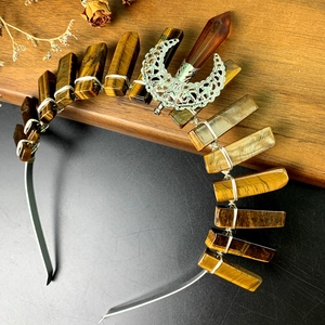 Macro detail of Bohemian crystal crown featuring moon alloy charm and tiger eye stones