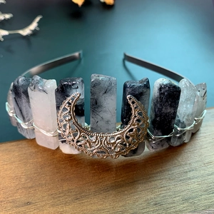Macro shot of handmade moon headband with natural black rutilated quartz crystals