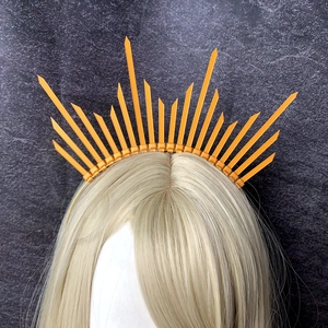 Macro detail of golden zip tie halo headband showing sunburst rays on a hair model