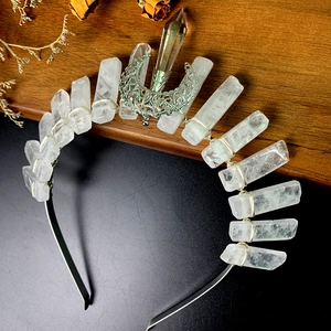 Detailed view of handmade crystal crown featuring hollow moon and wire wrapped raw stones