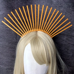 Detailed front view of bright orange sunburst halo crown hairpiece for parties