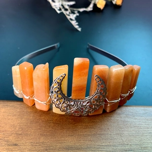 Handmade orange crystal crown headband with silver moon ornament on a metal base
