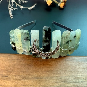 Macro shot of handmade natural green stone headband with wire-wrapped metal moon detail
