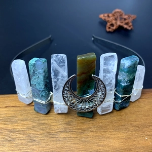 Macro detail of Bohemian moon headband with wire-wrapped crystals on wood