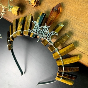 Detail of tiger eye crystal crown featuring silver moon ornament and hand-wrapped wire work