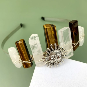 Detail of bohemian crown featuring tiger eye stones and silver sun pendant with wire wrapping