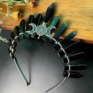 Macro detail of gothic crystal crown with silver wire wrap and triple moon symbol