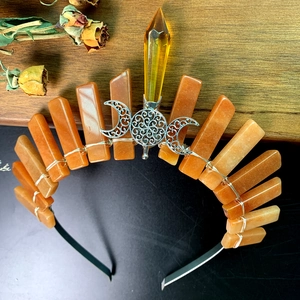 Macro view of crystal crown featuring orange quartz stones and silver triple moon celtic knots