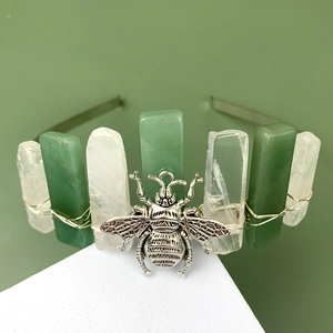 Detail of handmade crystal headband featuring green aventurine stones and a silver bee