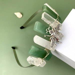 Detail of handmade moon headband with polished green stones and silver bee accent