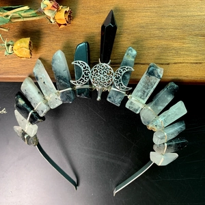 Detail of handcrafted bohemian crystal crown featuring moon and tree of life motifs