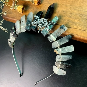 Detailed macro view of handmade crystal crown with moon pendant and wired metal headband