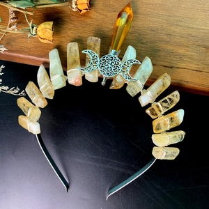 Detail of handmade bohemian bridal crown with yellow crystals and moon centerpiece