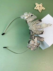 Detail of handmade gothic headband with raw crystals, silver bee, and crescent moon pearl