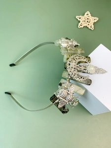 Detailed shot of silver forest crown with raw green crystals and bee metal ornaments