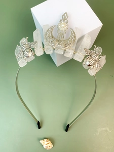 Detailed close-up of crystal tiara featuring silver moon, honeybee, and moonstone accents