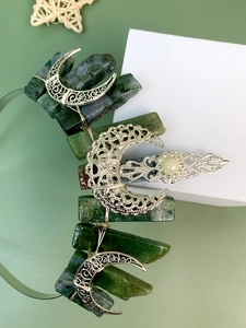 Detail of handmade crystal crown featuring green agate stones and silver moon filigree