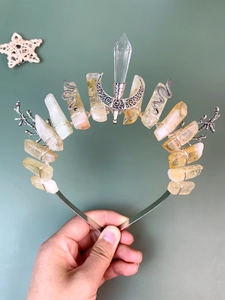 Macro detail of natural green aventurine crown with silver snake and moon accents