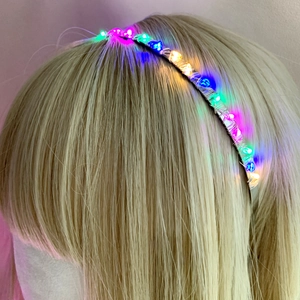 Macro view of multi-color LED glowing beads on silver wire headband for hair decoration