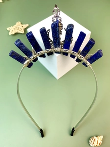 Macro detail of natural lapis lazuli stones and vintage metalwork on a crystal crown