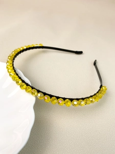 Detailed side view of handmade crown headband with faceted yellow beads on black wire