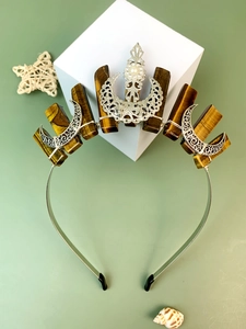 Detail of bohemian crown headband with tiger eye stones, metal moon and pearl