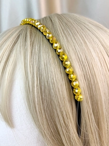 Detail of yellow crystal beads on a metal crown headband for bridal party hair accessory