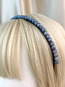 Detailed close-up of gray-blue faceted crystal beaded crown headband on a model headpiece